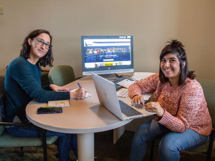 two students studying together in computer lab